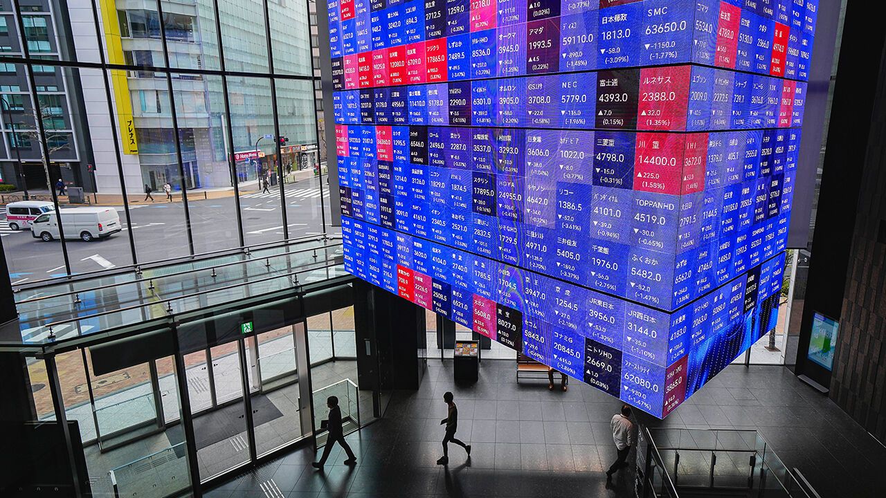 A screen displays share prices of Nikkei 225 on the Tokyo Stock Exchange inside the Kabuto One building in Tokyo, Japan
