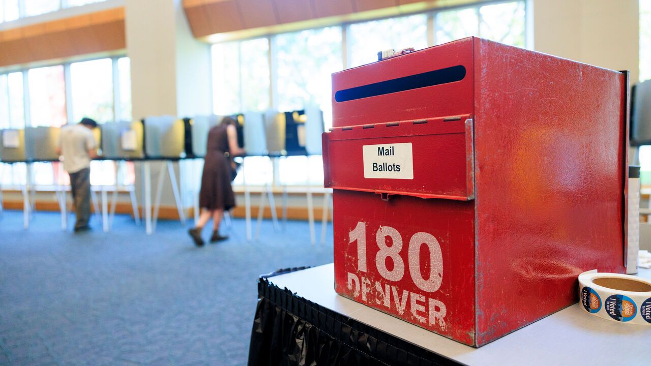 A red box for mail ballots sits at a polling place at the Central Library for Colorado's primary election in Denver, Colorado, USA.