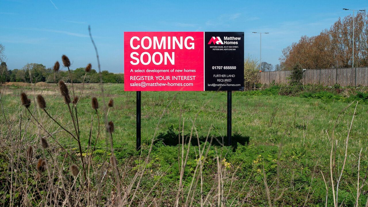 A sign reads 'coming soon'. Matthew Homes has bought a small plot of land off the London Road in Datchet, Berkshire next to the M4, UK.