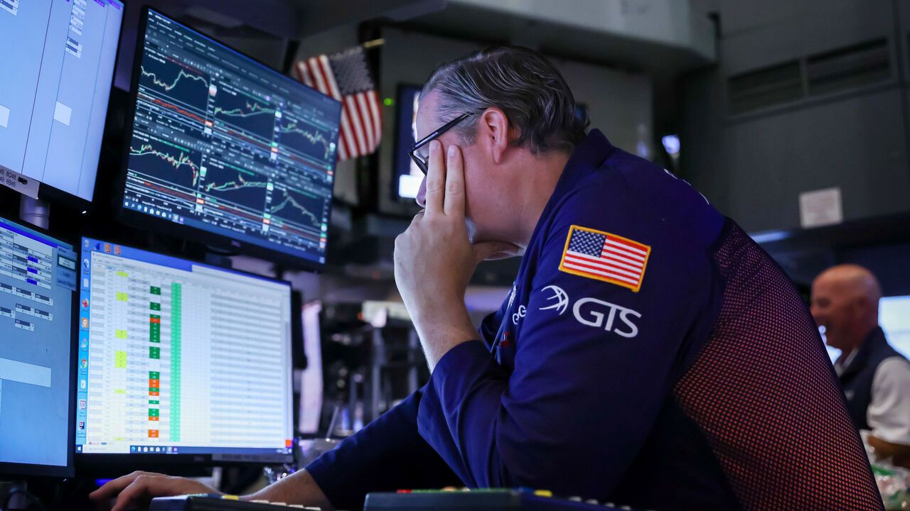 A trader works on the floor of the New York Stock Exchange.