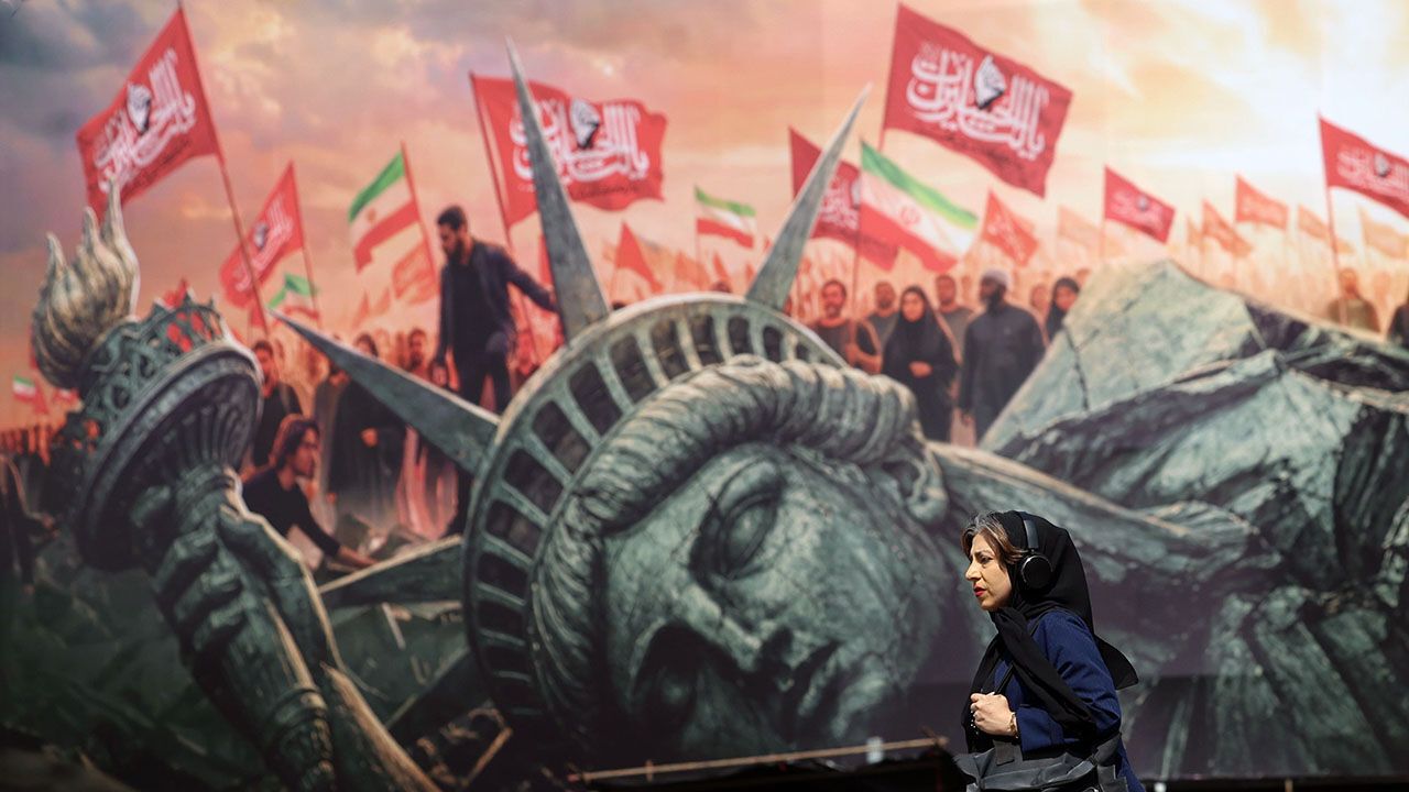 A woman walks past an anti-US bilboard in Tehran, Iran
