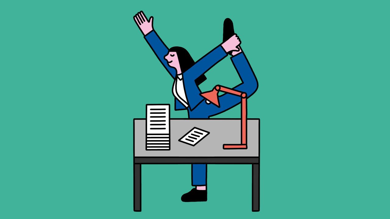 A woman in a standing yoga pose at an office desk