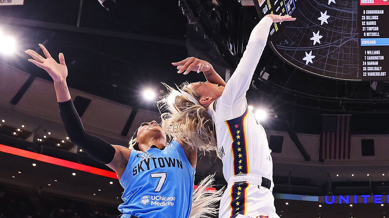 Sophie Cunningham of the Indiana Fever is fouled by DiJonai Carrington of the Chicago Sky.