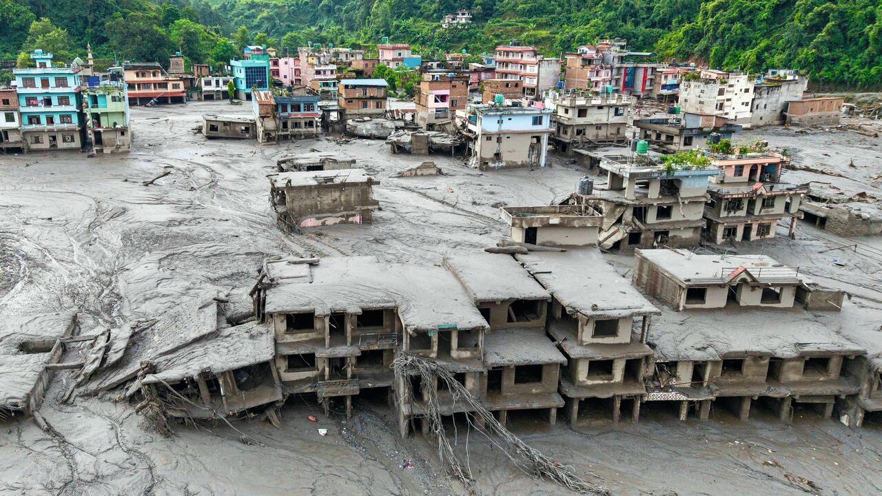 An aerial view shows houses lying deluged in sludge after flash floods at Devighat, Bidur Municipality in Nepal's Nuwakot district on August 27, 2026.
