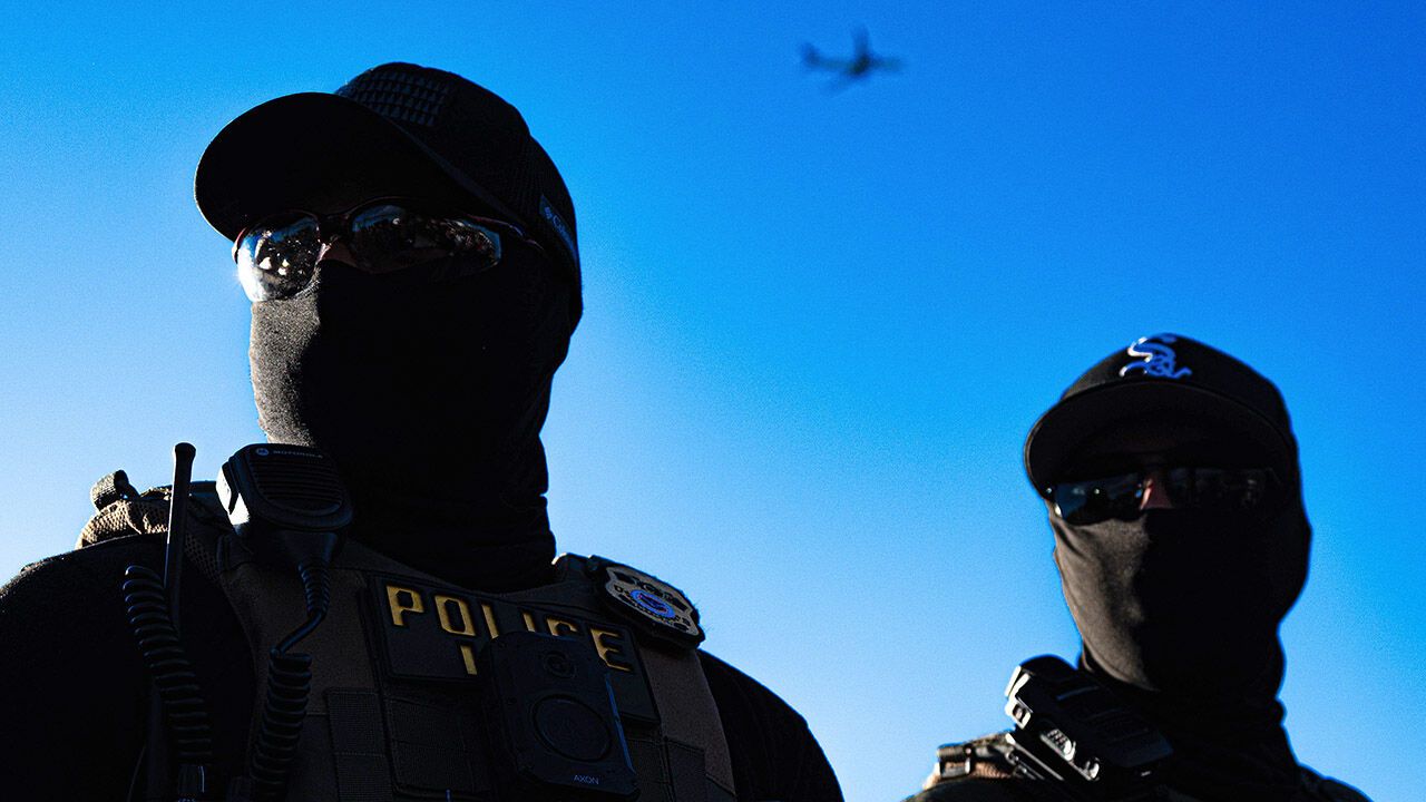 Two Immigration and Customs Enforcement agents stand outside the Delaney Hall Detention Center in Newark, New Jersey.