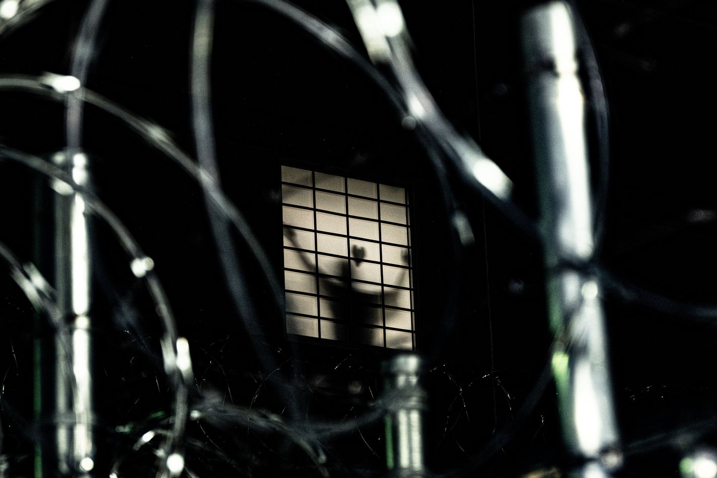 A detainee attaches a paper heart to a window and gestures to protesters outside the Delaney Hall detention center in Newark, New Jersey.