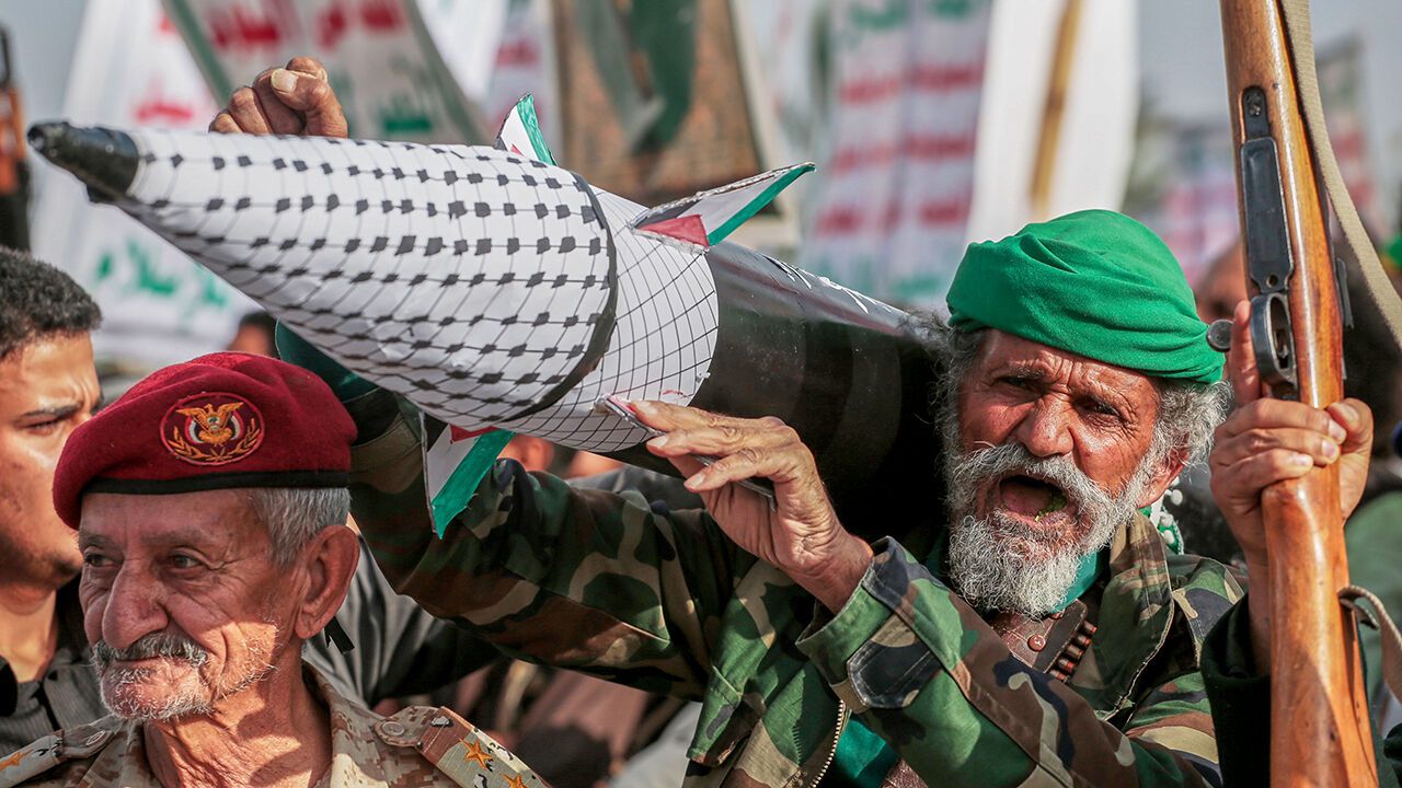 A Houthi supporter chants slogans as he carries a rocket replica during an anti-U.S. and anti-Israel rally in Sanaa, Yemen