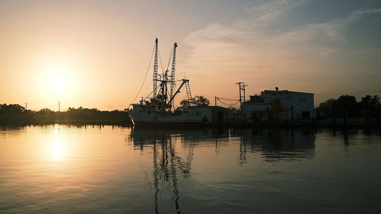 Shrimp boats docked at sunrise of Bayou Grand Calliou, Terrebonne Parish, Louisiana.