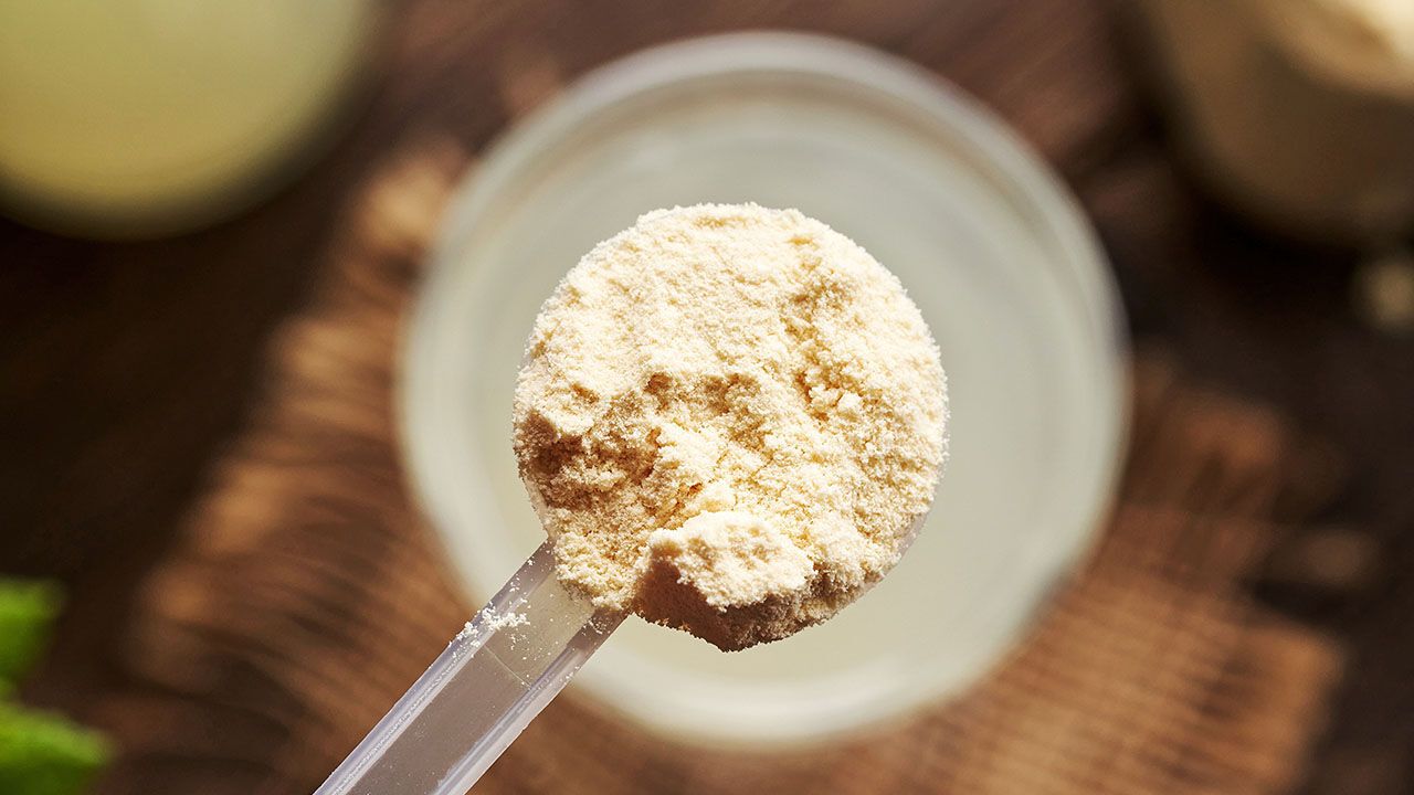 Whey protein powder in a measuring cup