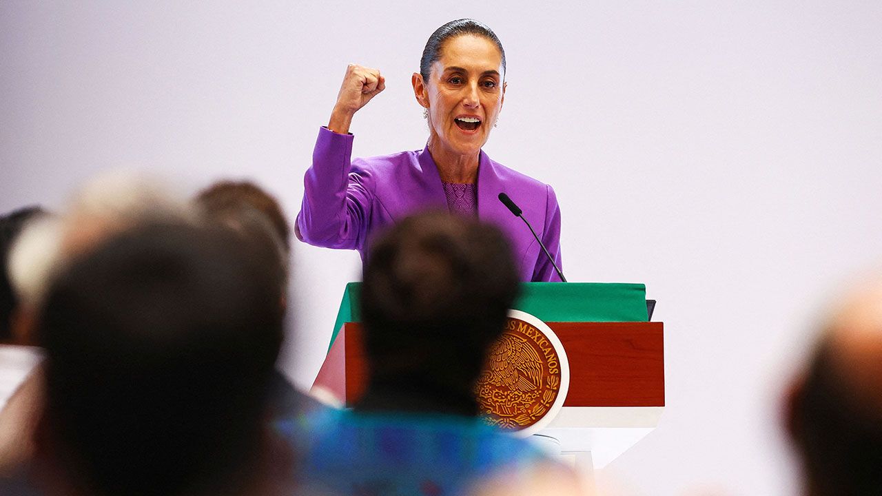 Mexico's President Claudia Sheinbaum pumps her right fist in the air as she delivers a speech marking her second year in office, in Mexico City, Mexico.