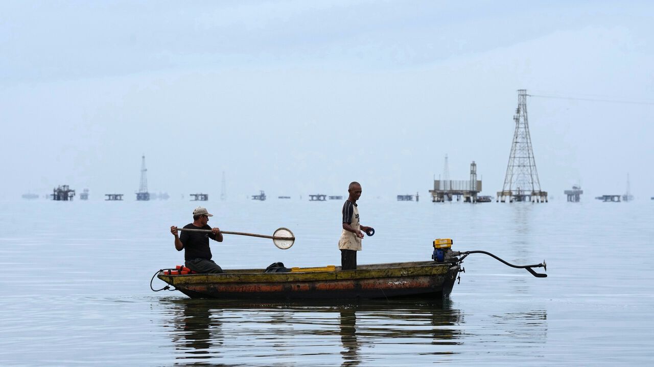 Fishermen cast their lines from a boat on Lake Maracaibo.