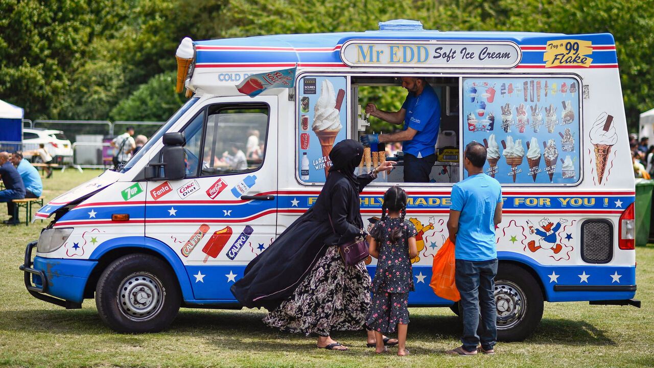 A family buys ice creams during Boishakhi Mela, a festival celebrating the Bengali New Year.
