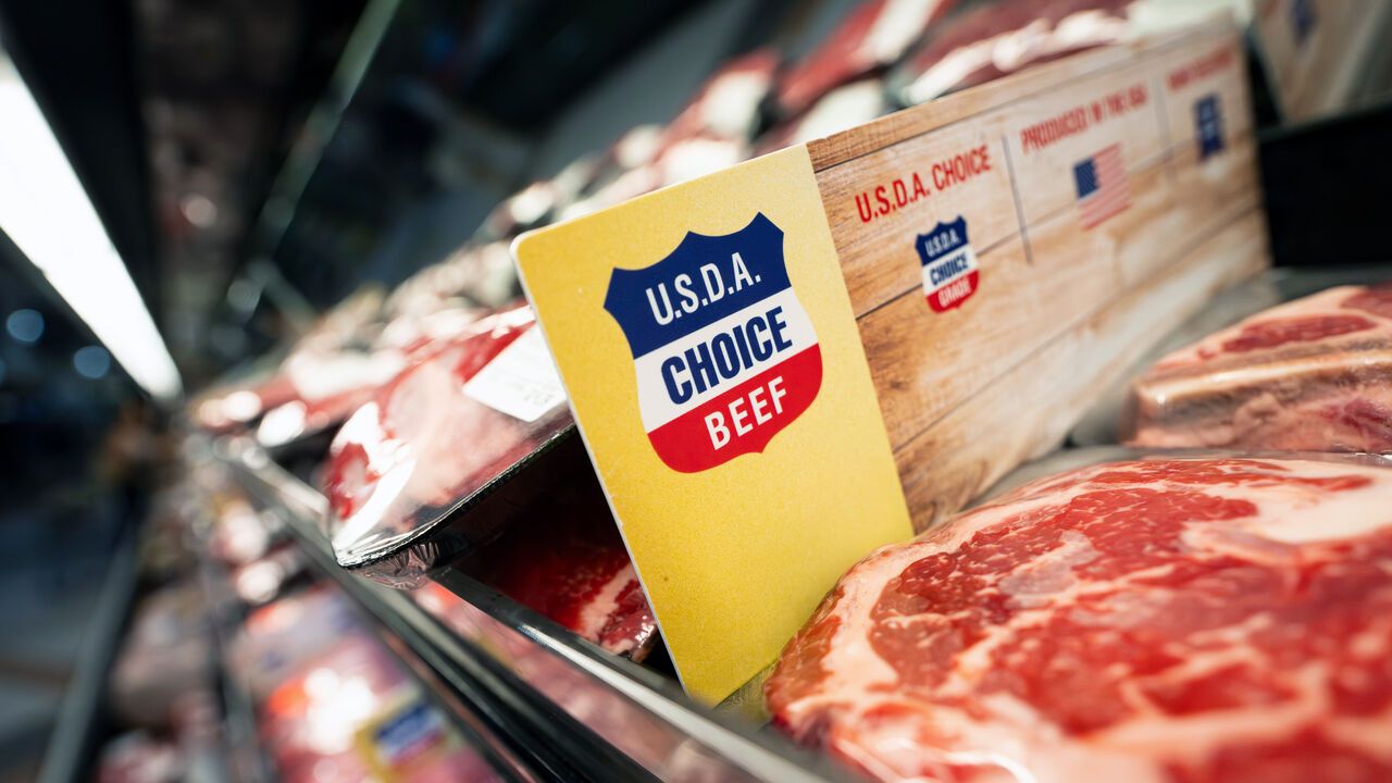 A United States Department of Agriculture (USDA) choice sign next to angus beef.