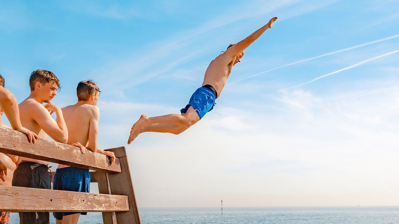 A man jumps into the sea during summer in Broadstairs, Kent, UK.