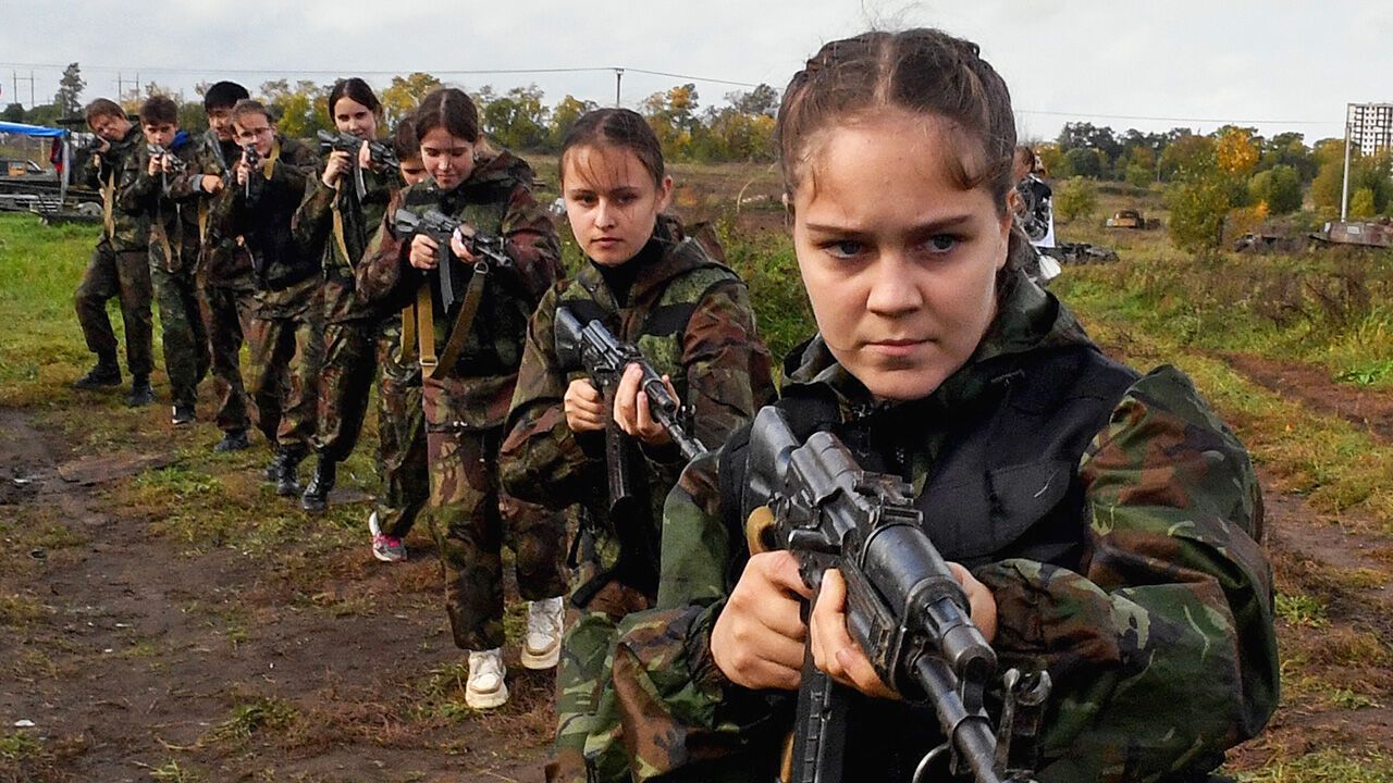 Girls belonging to a patriotic club hold guns during a competition at the Military-Patriotic Festival in St. Petersburg, Russia