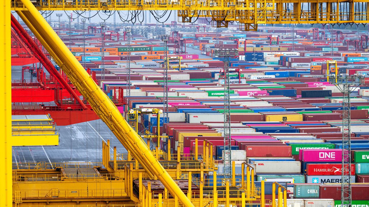 The yellow frame of a container bridge shows containers stacked at the overseas port of Bremerhaven, northwestern Germany.