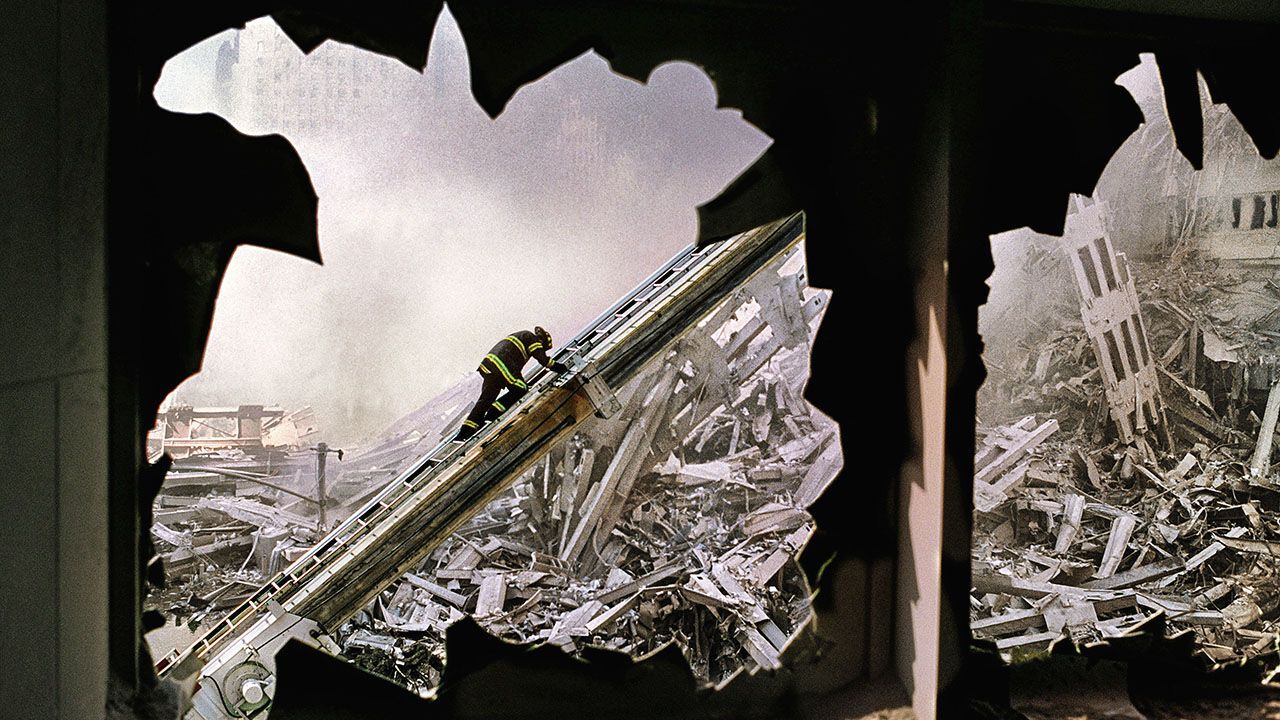 Firefighter seen through blown out windows of the World Financial Center on September 11th, 2001.