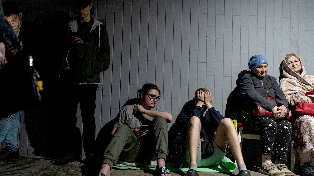 Residents gather outside a damaged residential building following a Russian missile strike in Kyiv