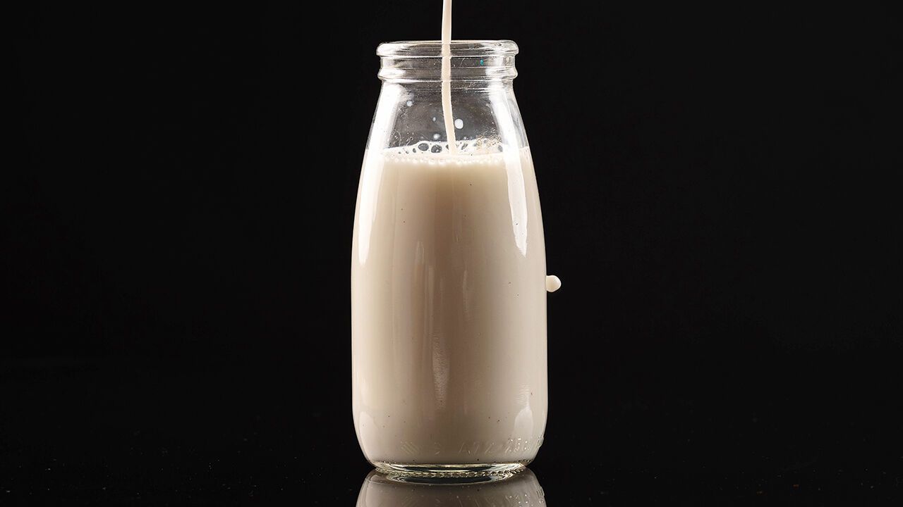 Milk pouring into a bottle