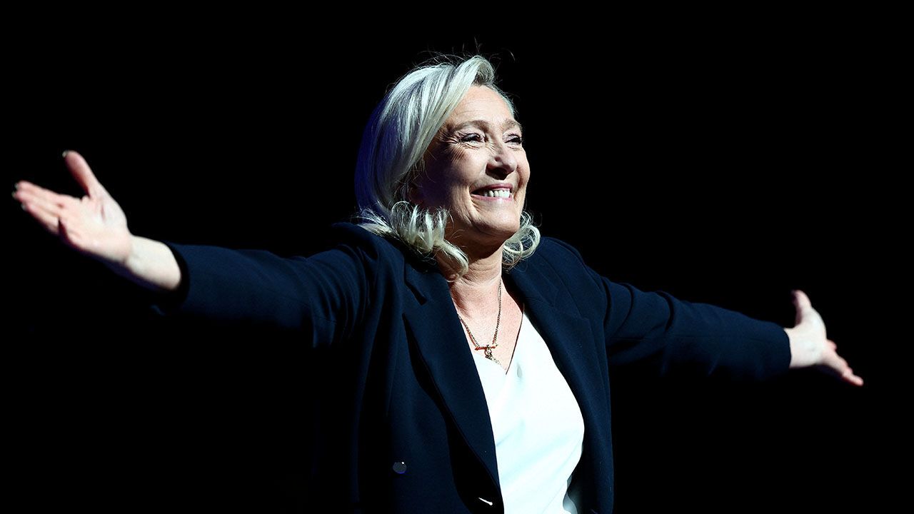 Marine Le Pen with arms outstretched
