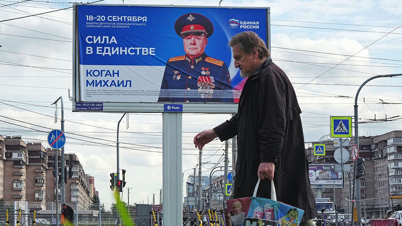 A man walks past a billboard for a United Russia party's candidate, before the parliamentary and local elections in St. Petersburg, Russia, September 15th 2026