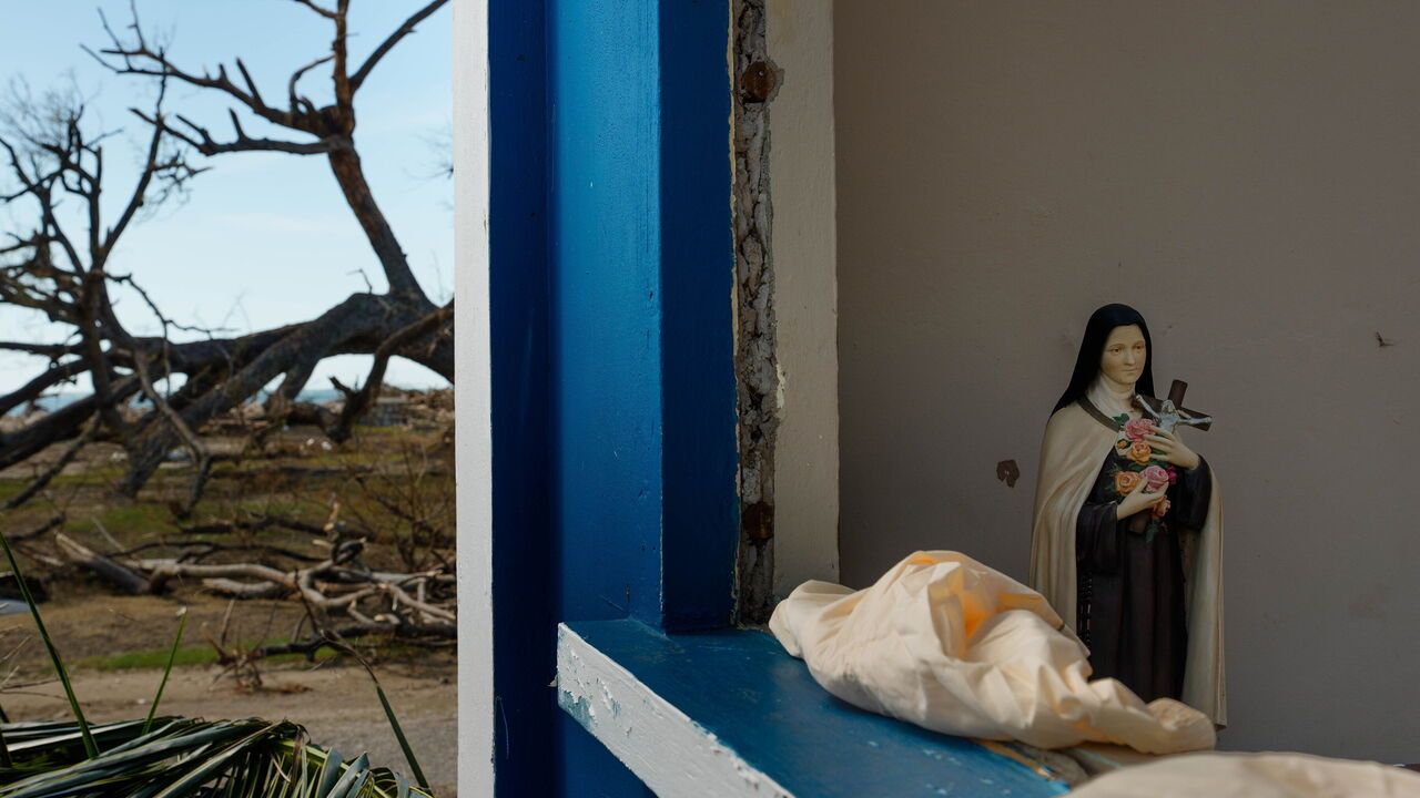 An statue of the Virgin Mary sits in tact in the remains of a church devastated by Hurricane Melissa in Jamaica