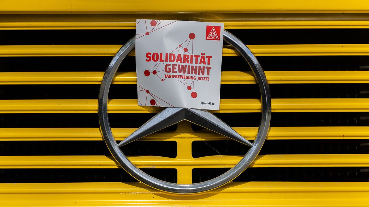 A sticker reading “Solidarity Wins” is affixed to the Mercedes star  at IG Metall's Nationwide Automotive Action Day
