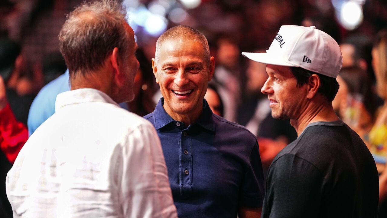 Ari Emmanuel interacts with Actor Mark Wahlberg during a UFC event.