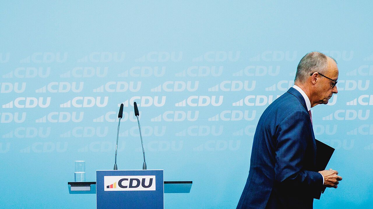 Friedrich Merz walks away from a podium