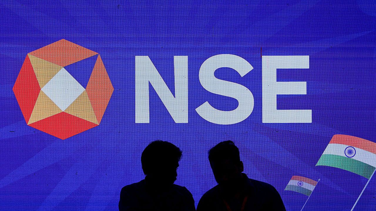 People talk inside the National Stock Exchange in Mumbai