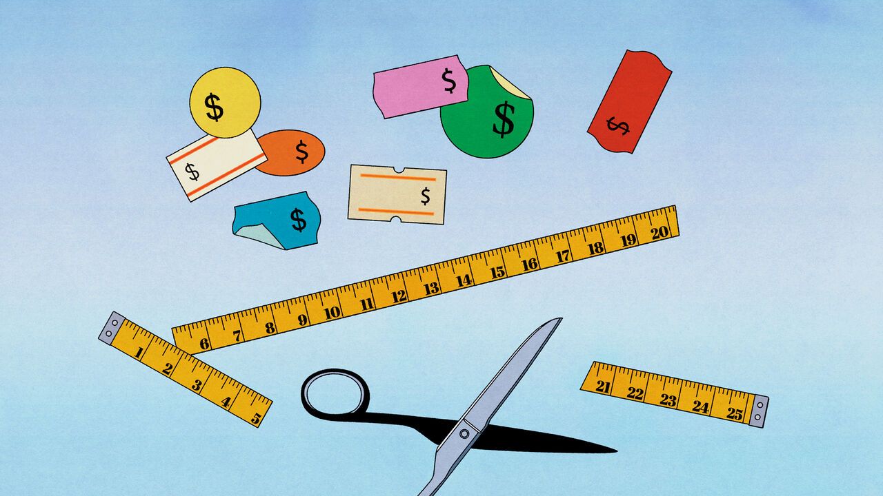 Coloured price labels with a measuring tape underneath being cut with scissors