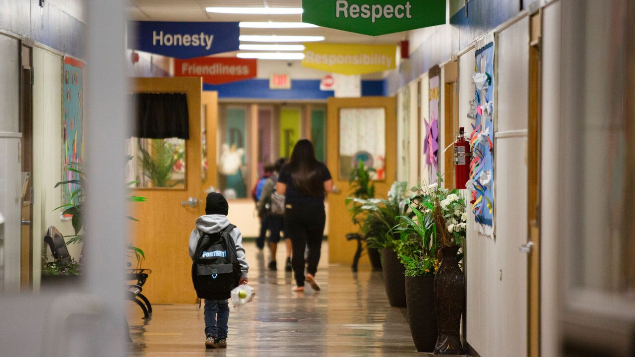 Students walk in a hallway at Dudley Elementary School in Victoria, Texas.