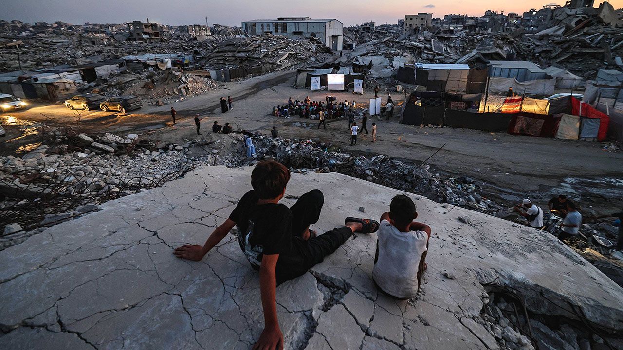 Displaced Palestinian children watch a film at an open-air cinema in Gaza