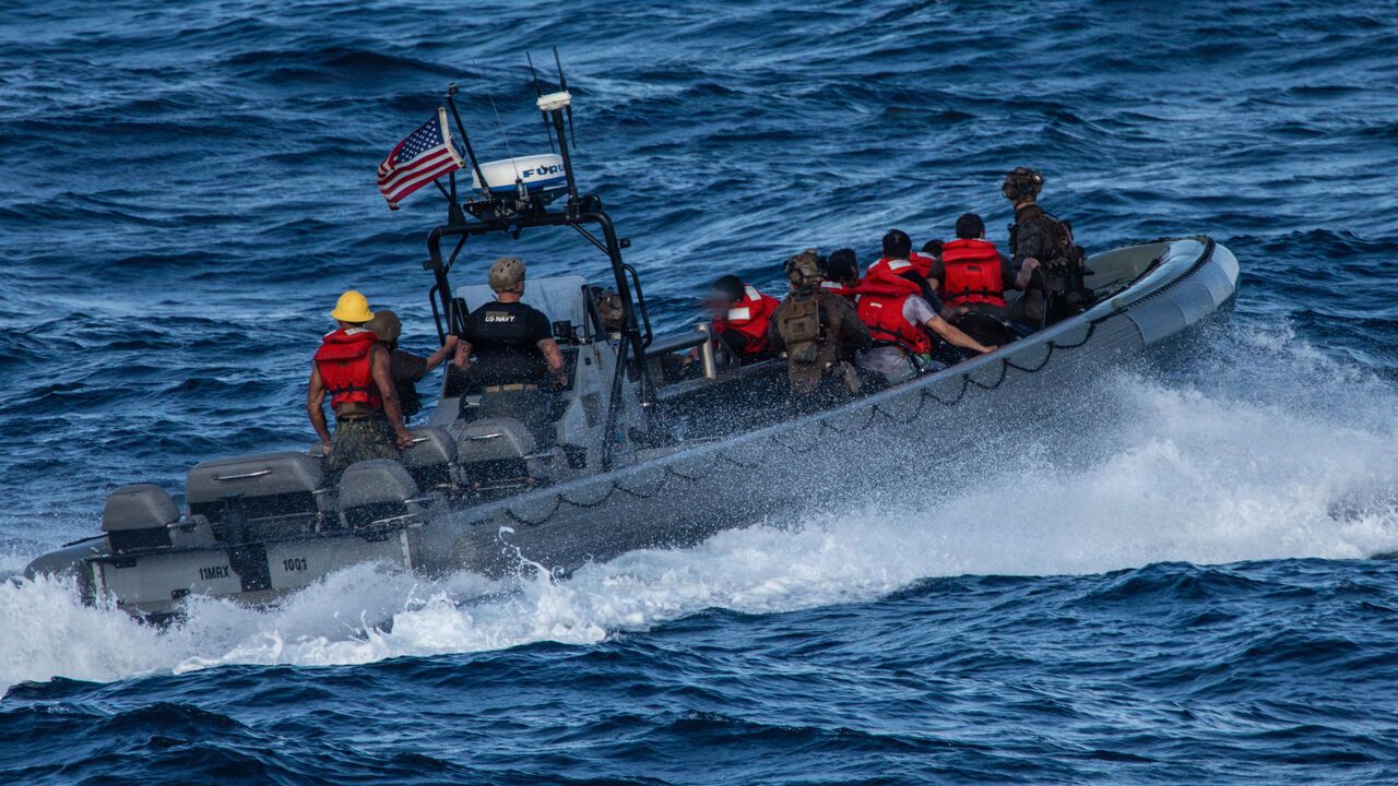 U.S. Marines with Littoral Combat Force-24, and U.S. Sailors with San Antonio-class amphibious transport dock USS San Antonio approach Ecuadorian Coast Guard ship Isla San Cristobal a Maritime Interdiction Operation in the Pacific Ocean.