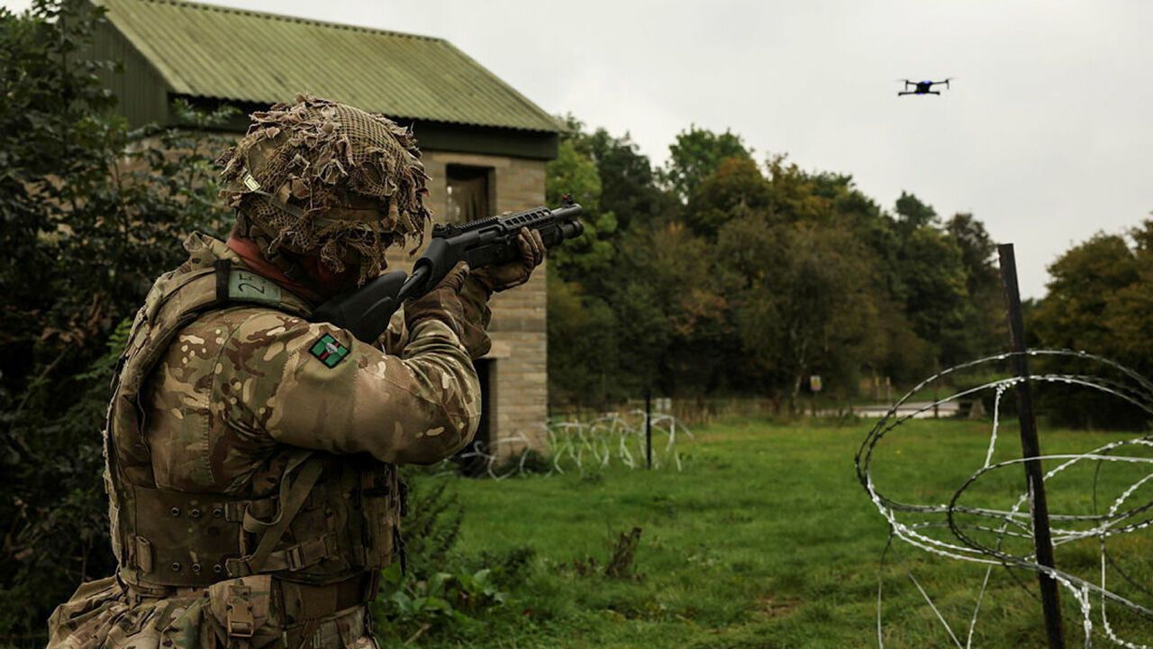 A soldier from 2nd Battalion The Royal Yorkshire Regiment fires a combat shotgun at an enemy drone