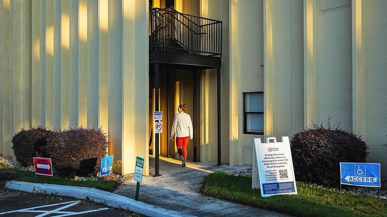 A voter enters a polling location on the first day of early voting for the midterm election in Atlanta.