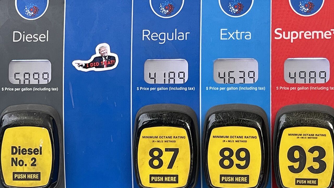 A sticker of President Donald Trump saying "I did that" is seen referring to the price of gas at a Mobil gas station
