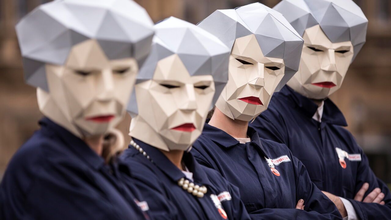 Protestors are dressed as "Maybots" satirising Theresa May