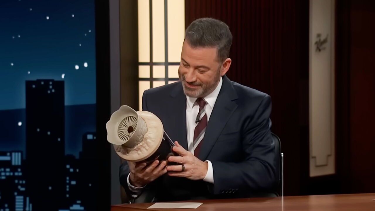 Jimmy Kimmel holds a Dune 2 sandworm popcorn bucket on the Jimmy Kimmel Live show.