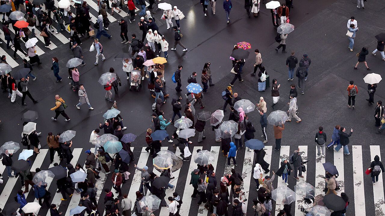 People cross the Shibuya Crossing in Tokyo, Japan