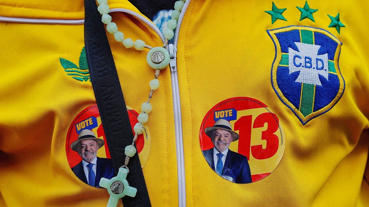 A person wears a jacket with stickers depicting Brazilian President and Workers' Party (PT) candidate for re-election Luiz Inacio Lula da Silva.
