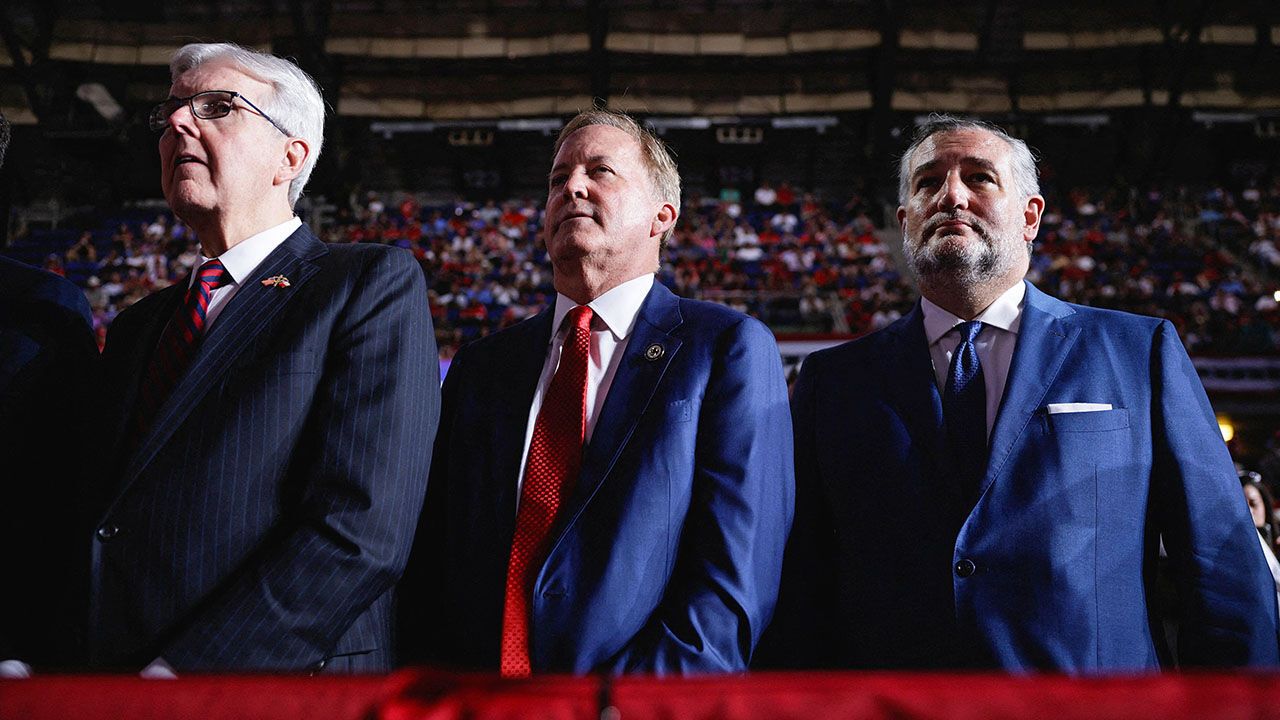 Republican candidate for US Senate Ken Paxton and US Senator Ted Cruz (R-TX) listen as US President Donald Trump speaks during a campaign rally for Paxton.