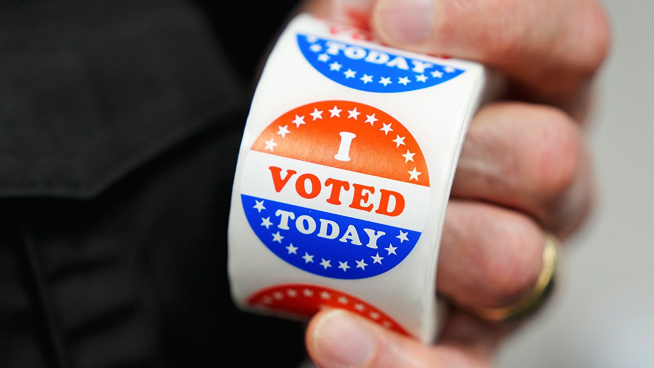 A worker holds "I voted today" stickers during early voting.