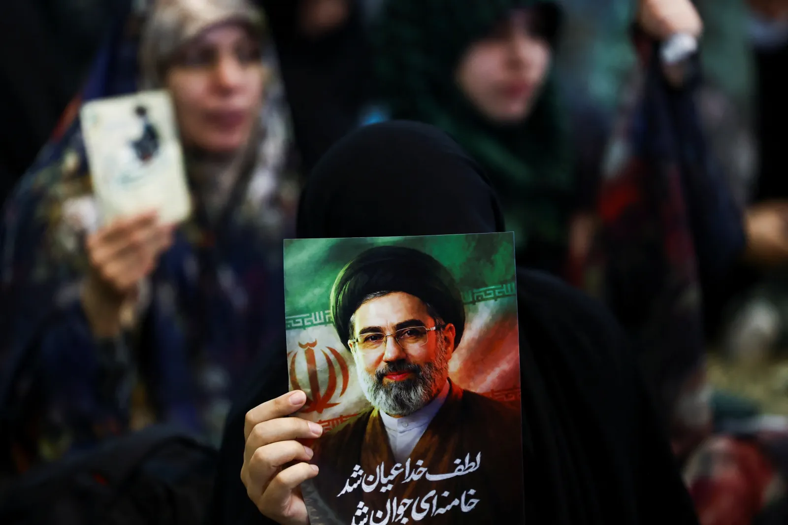 A woman holding a picture of Mojtaba Khamenei, Tehran, March 2026