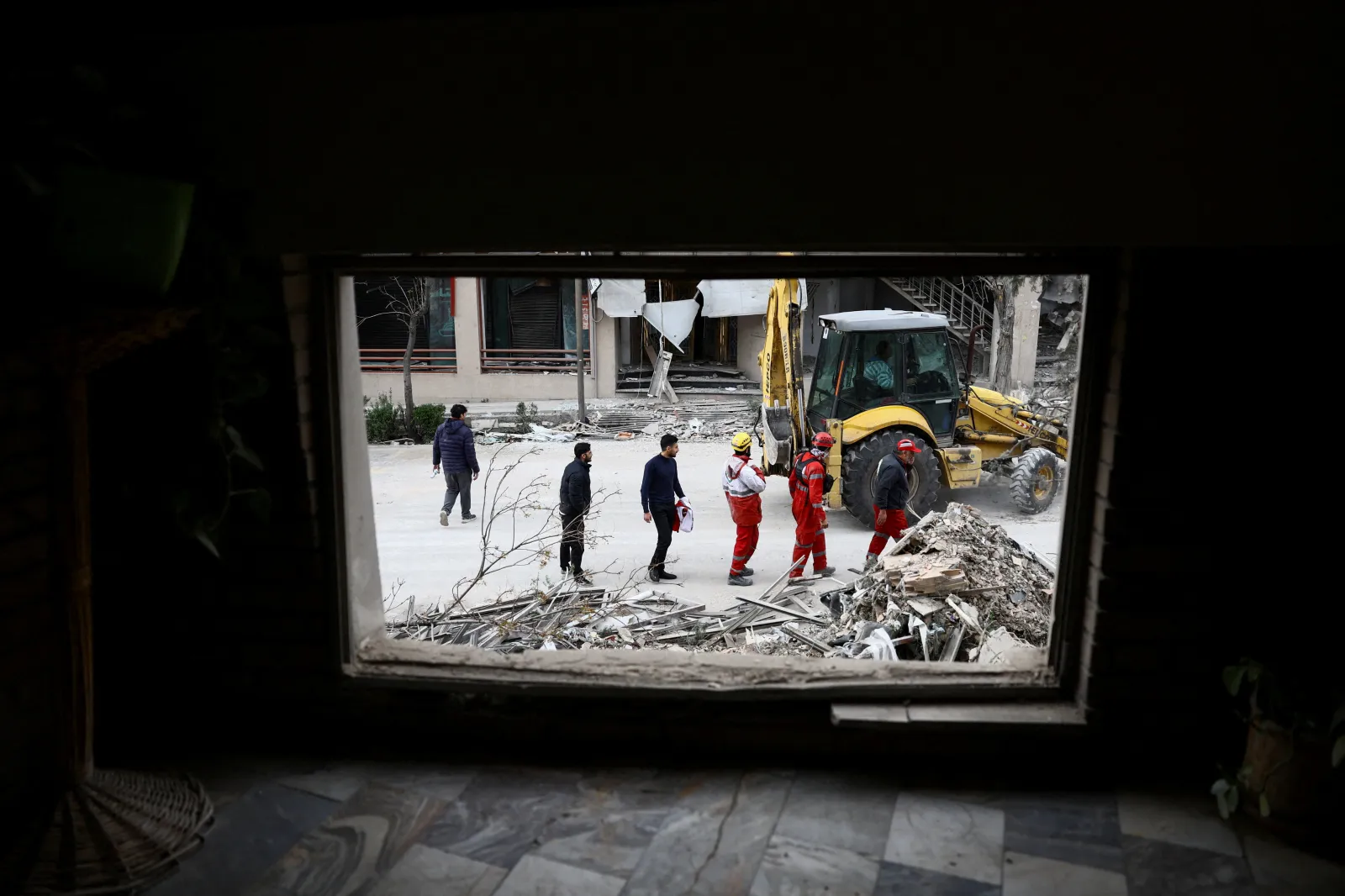 Emergency responders at a building damaged by a strike in Tehran, Iran, March 2026
