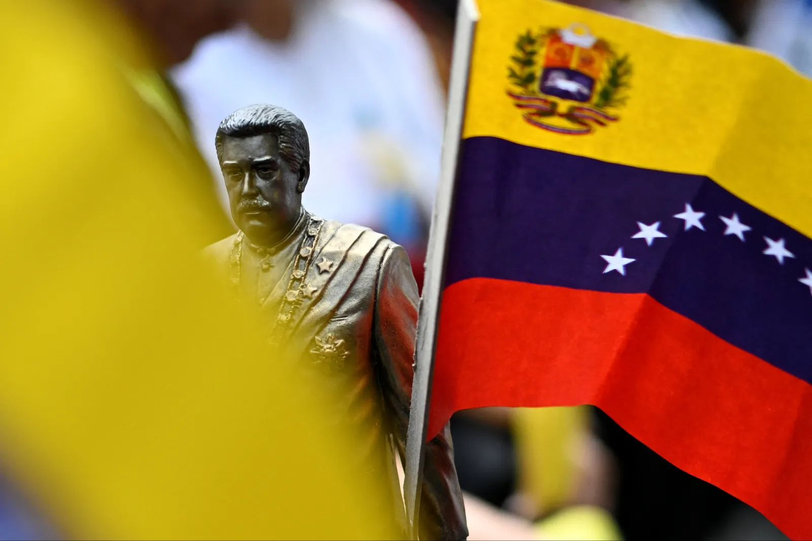 A supporter holds a figurine depicting ousted Venezuelan President Nicolas Maduro as people gather to show support for him and his wife Cilia Flores, as Maduro and Flores were attending a hearing in a Manhattan federal court, more than two months after U.